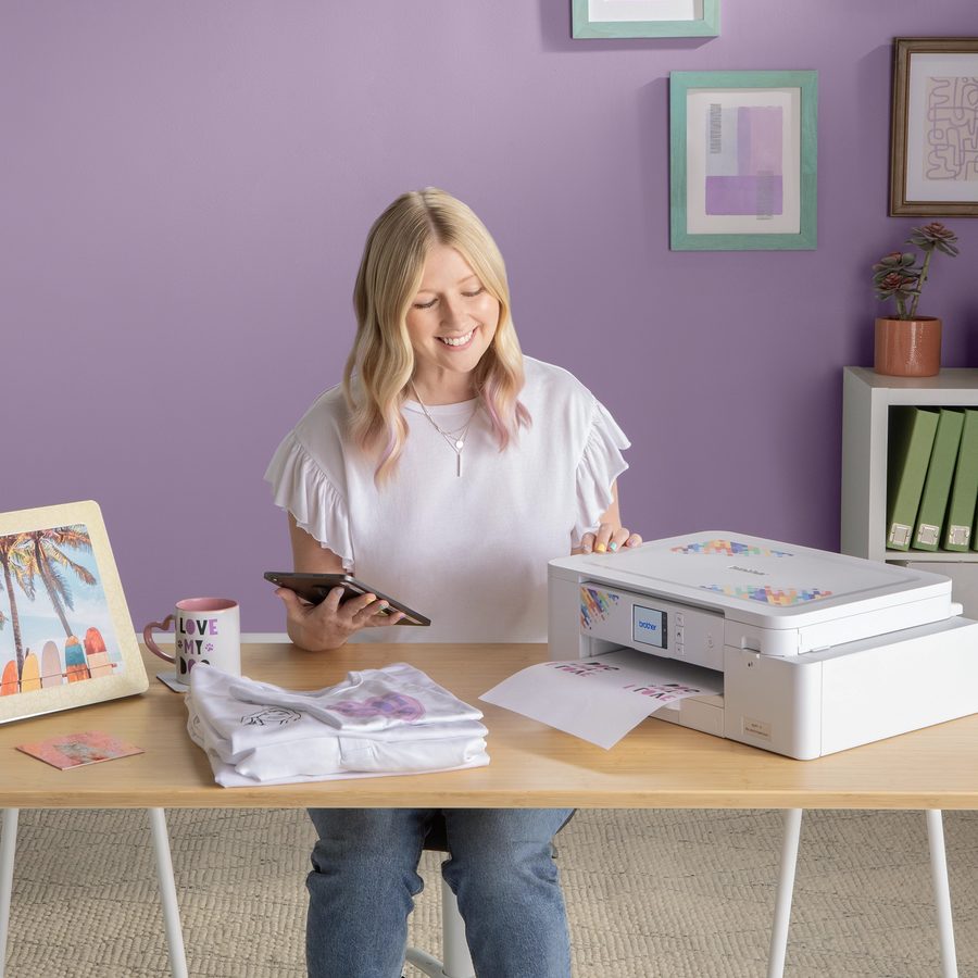 Woman using a Brother sublimation printer at a desk